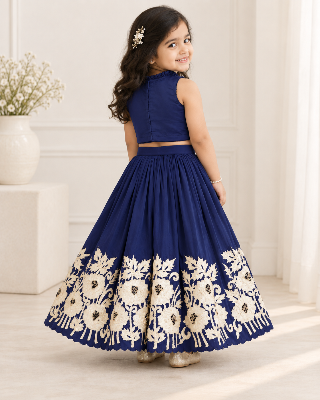 Girl twirling in royal blue embroidered lehenga set, front view