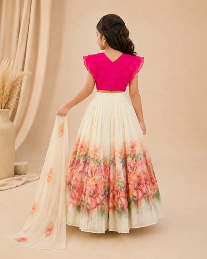 Woman wearing a pink top and floral skirt against a beige background