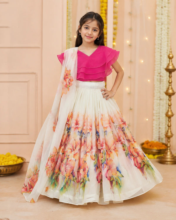 Young girl wearing a pink blouse and floral skirt with a decorative background