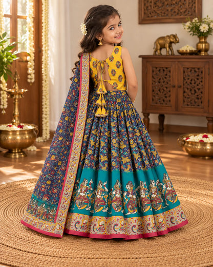 Girl wearing a yellow, navy and teal lehenga choli set