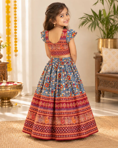 Blue and red printed girls lehenga choli set displayed flat