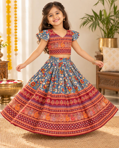 Girl wearing a blue and red floral lehenga choli set