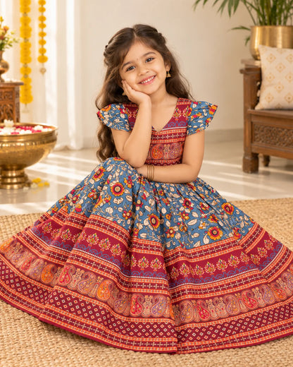 Girl wearing a blue and red printed lehenga choli set