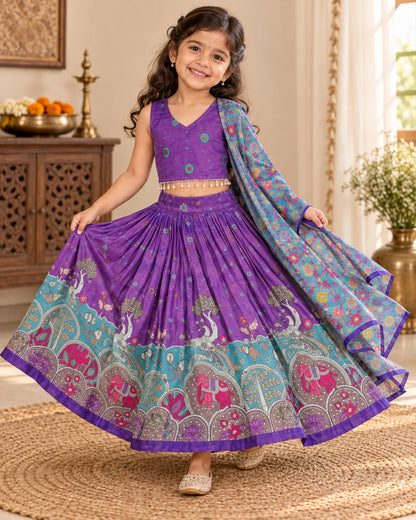 Girl wearing a purple and turquoise lehenga choli set at a festive celebration