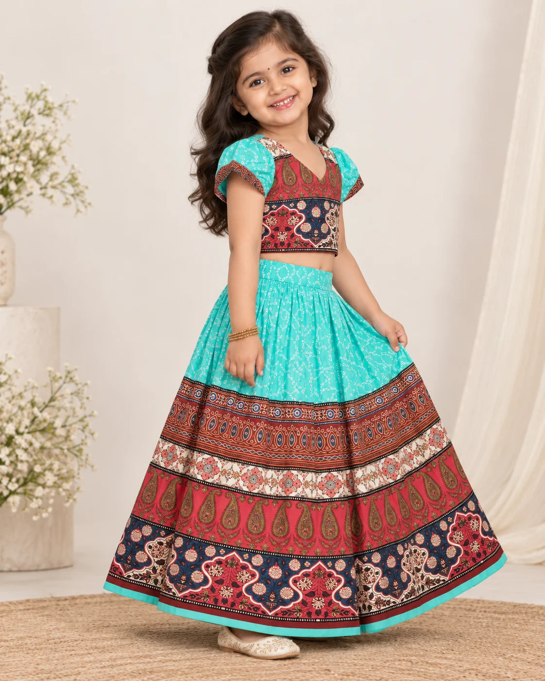 Back view of girl wearing a turquoise and maroon printed lehenga choli set