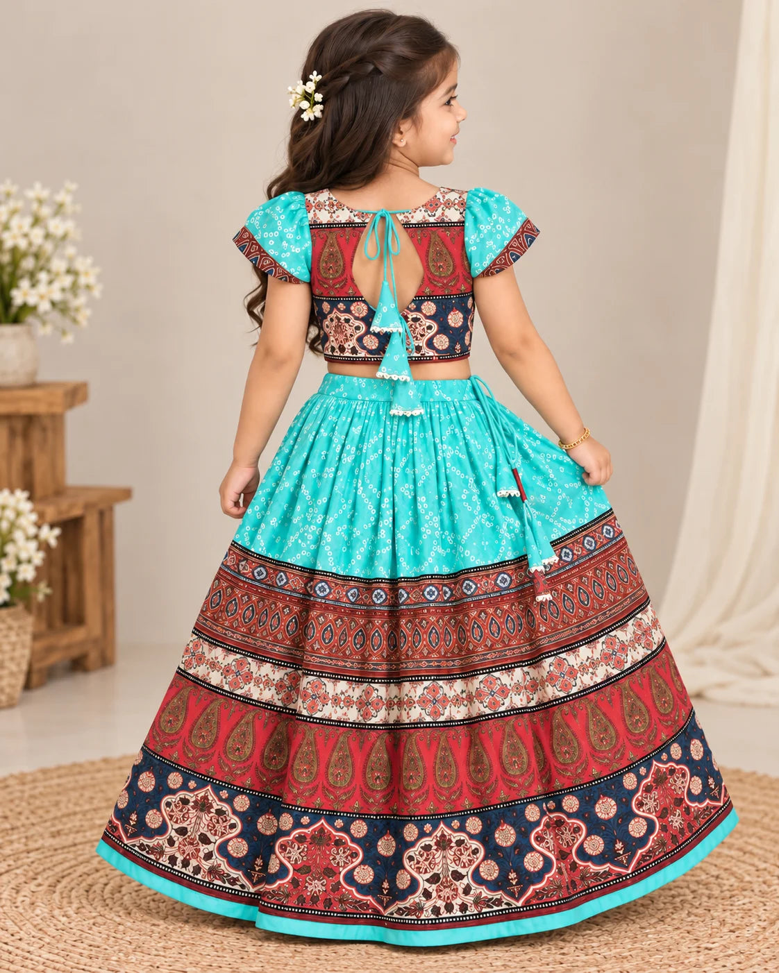 Girl posing in a turquoise and maroon printed lehenga choli set