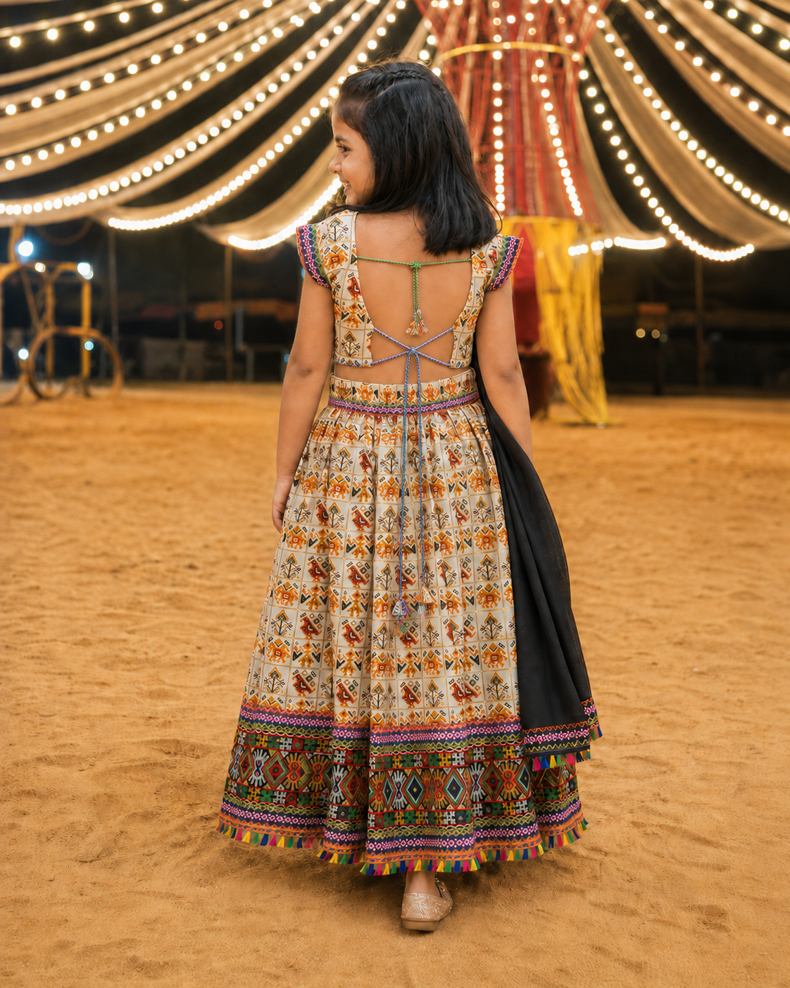 Cream Kaju Katri Patola Lehenga Choli - Girl Back View at Garba Ground