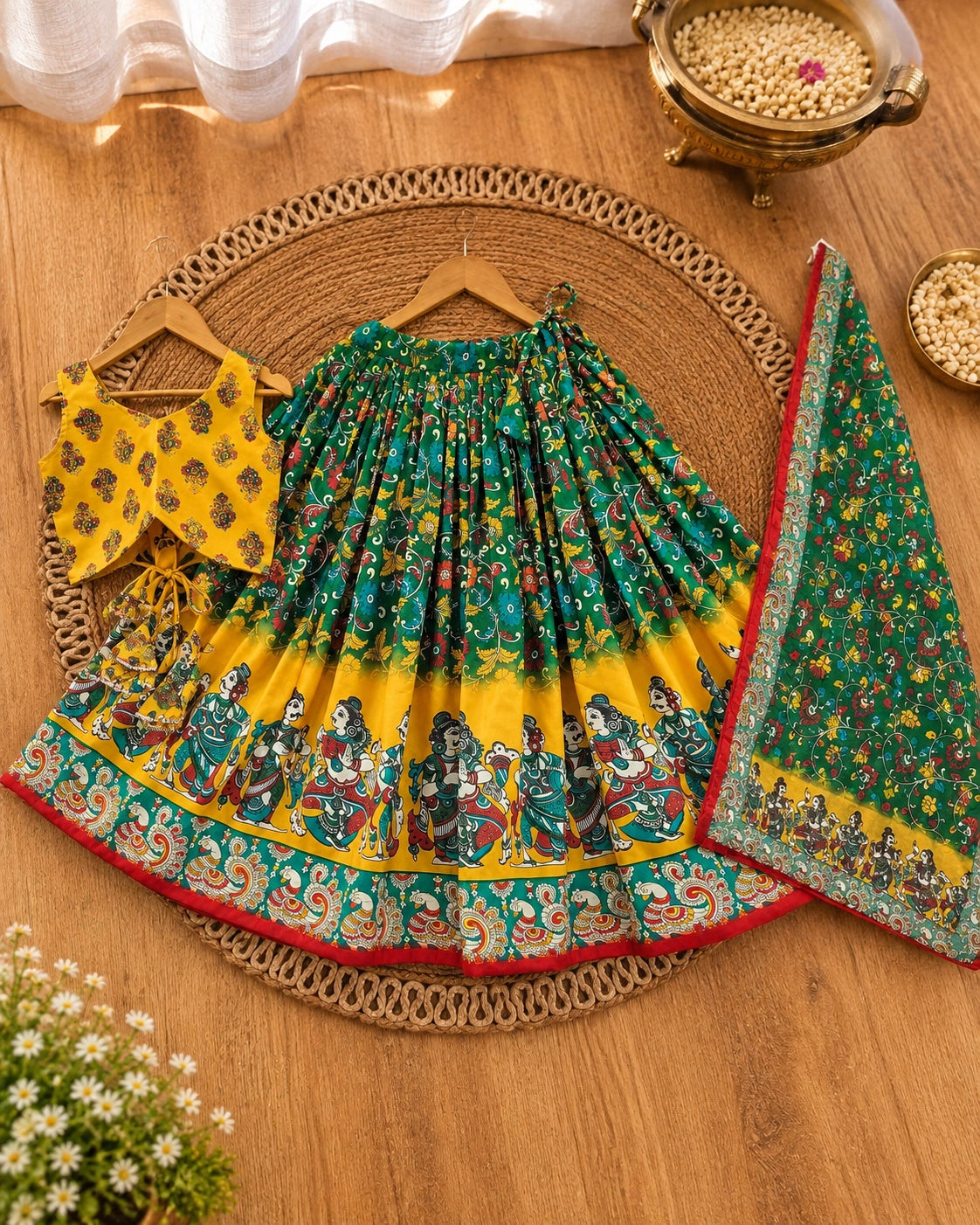 Girl wearing a yellow and green printed lehenga choli set with dupatta