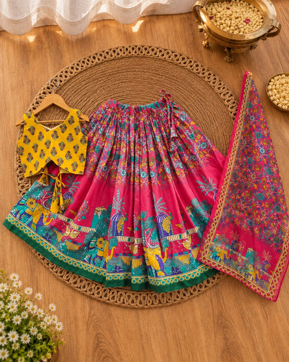 Girl wearing a bright pink and yellow girls lehenga choli set